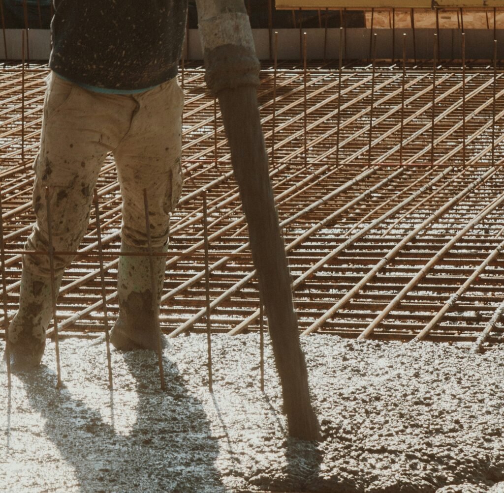 Pouring reinforced concrete for a commercial foundation slab.